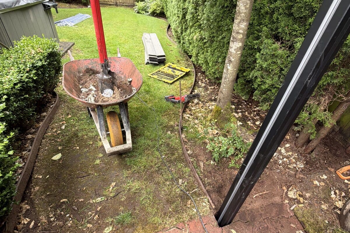 Proline fence posts being installed beside patio pavers
